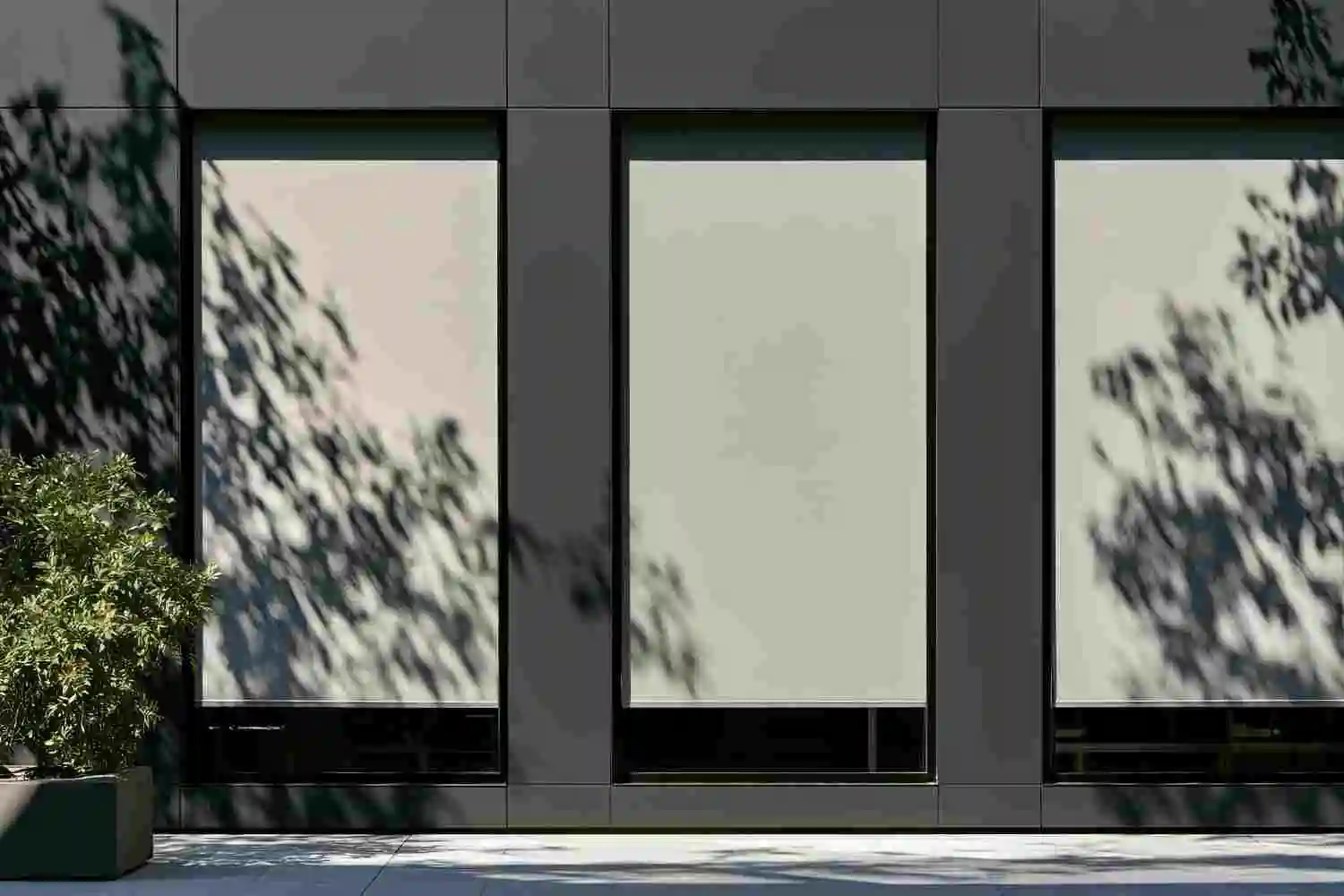 Exterior roller shades installed over modern windows to reduce sunlight and glare
